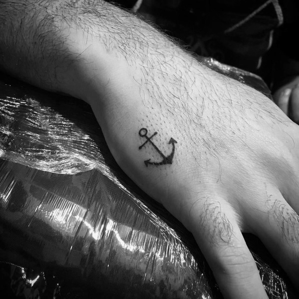 Tiny anchor tattoo on the hand