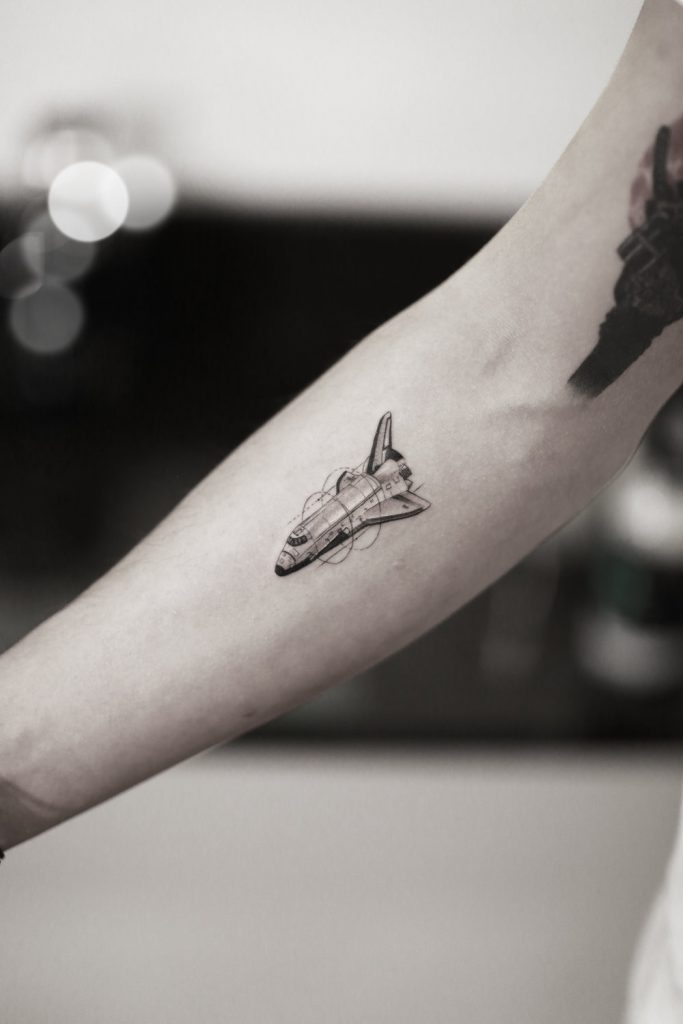 Tiny and super detailed spaceplane tattoo