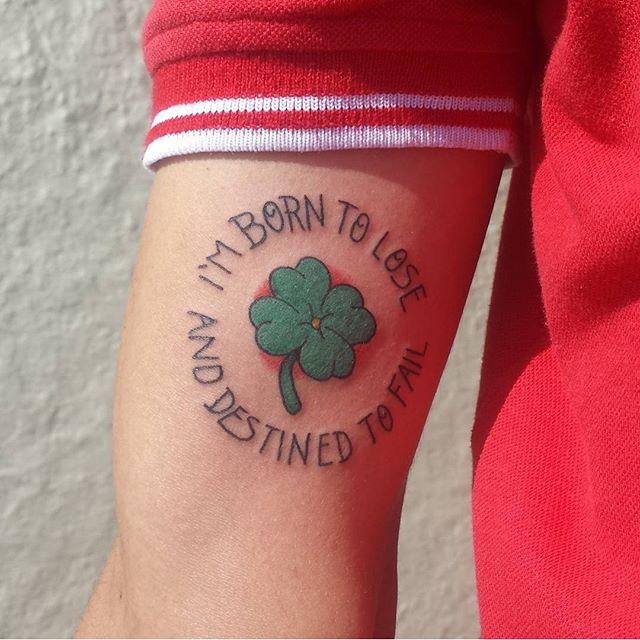 Traditional clover tattoo with a quote