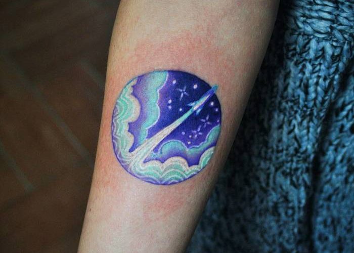Watercolor circular spaceship tattoo