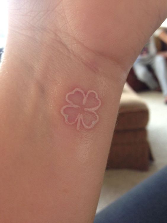 White four leaf clover tattoo