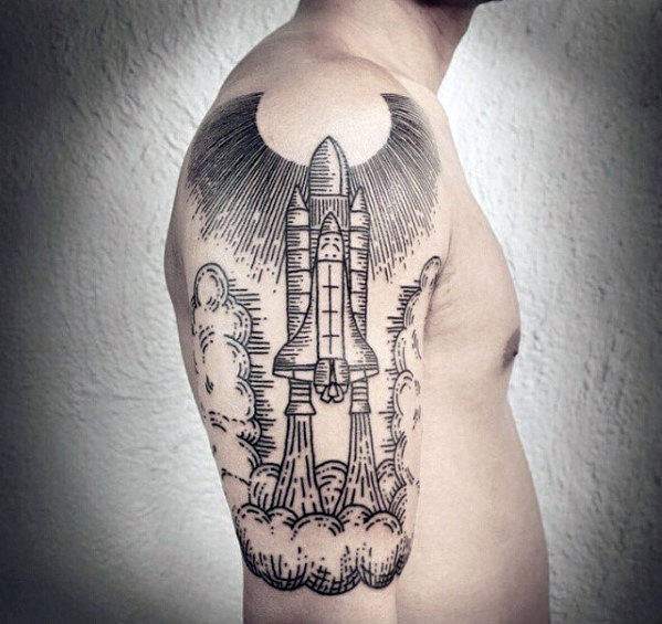 Woodcut spaceship tattoo o nthe right upper arm