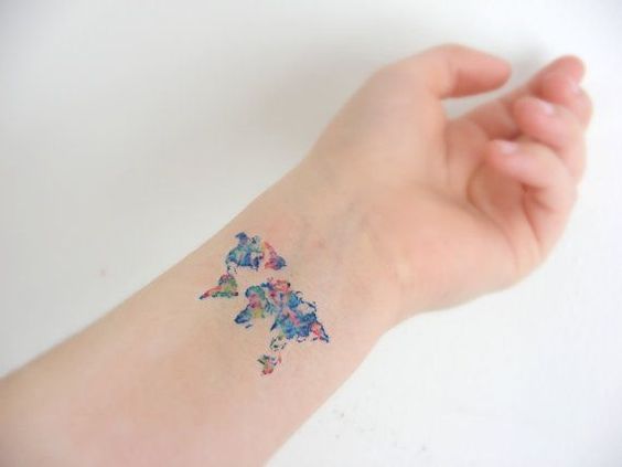 Colorful world map tattoo on the inner wrist