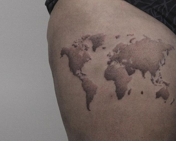 Dotwork style world map tattoo on the right thigh