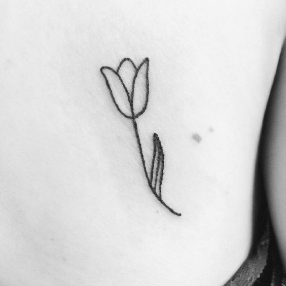 Minimalist black and white tulip tattoo