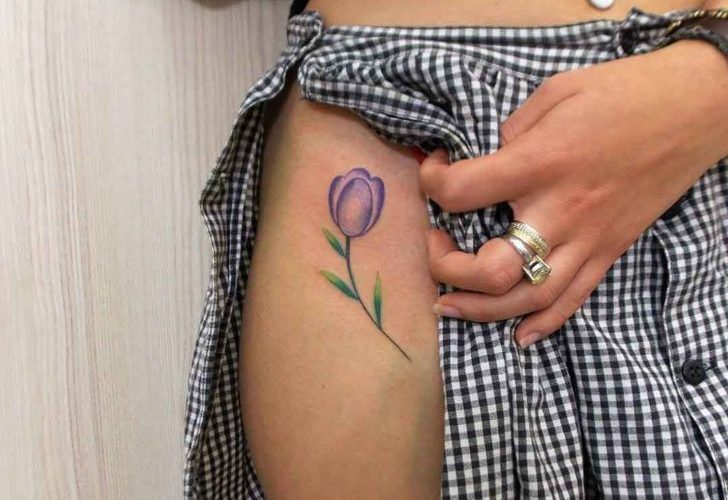Purple tulip tattoo on the right hip