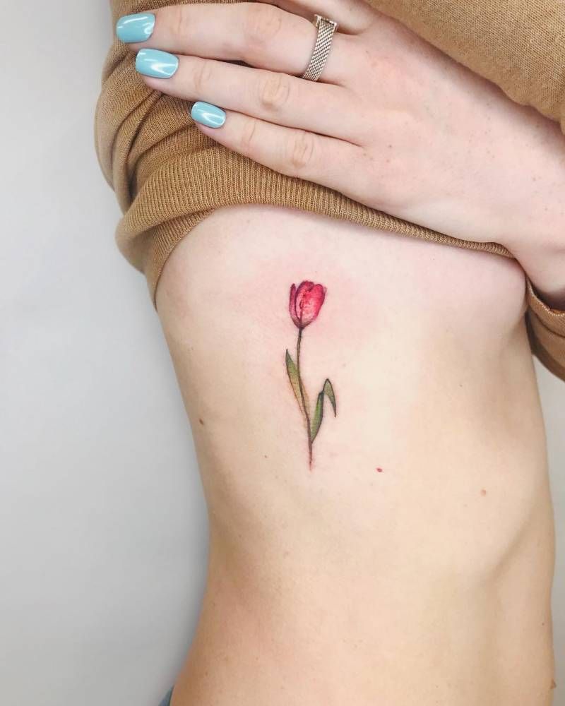 Red tulip tattoo on the right rib cage