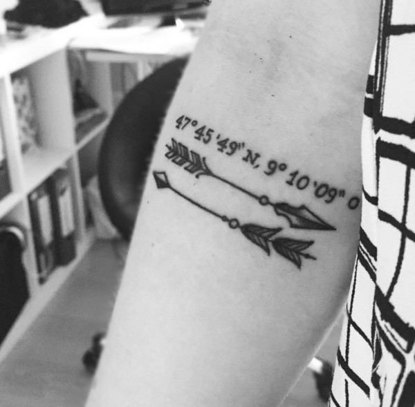 Two arrows and coordinates tattoo