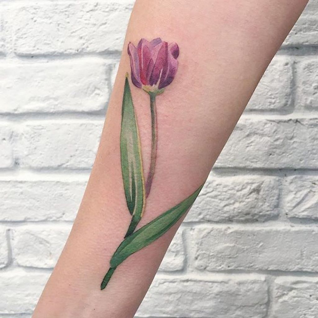 Watercolor pink tulip tattoo on the arm