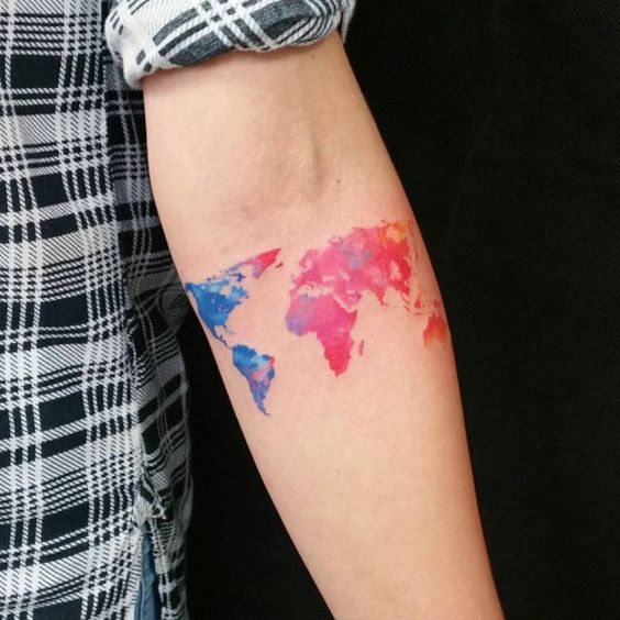 Watercolor world map tattoo on the forearm