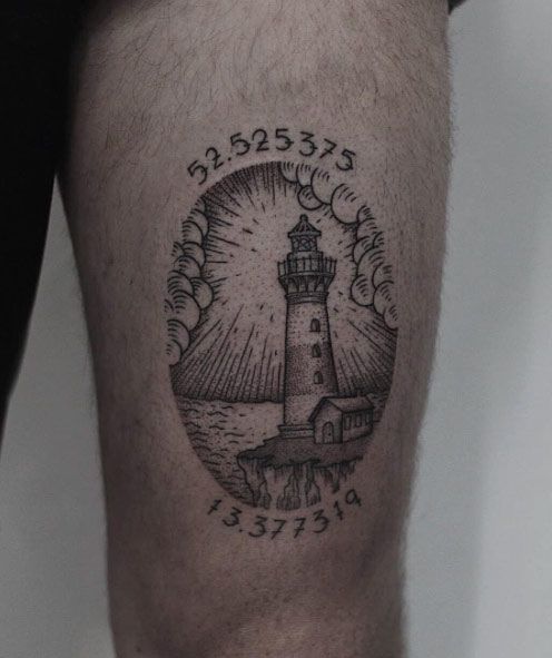Woodcut lighthouse and coordinates tattoo on the left thigh