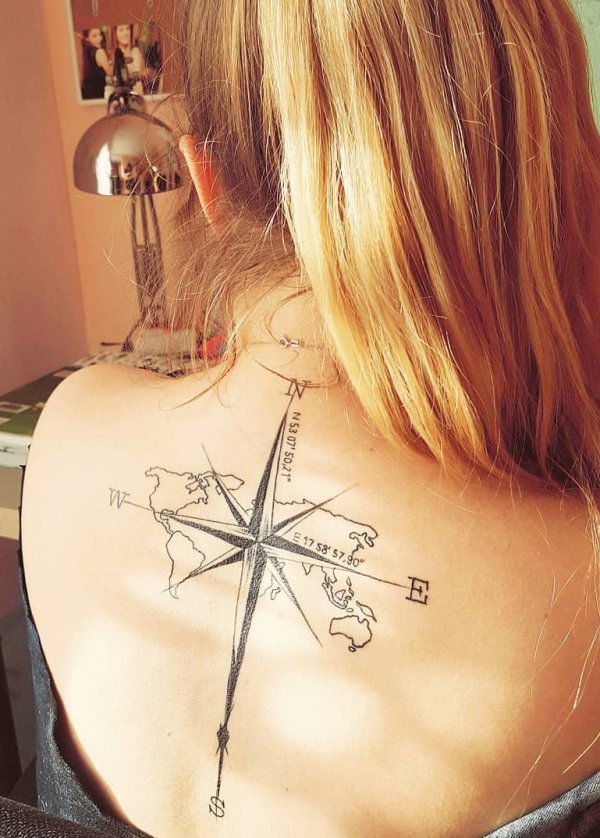 World map compass and coordinates tattoo on the back