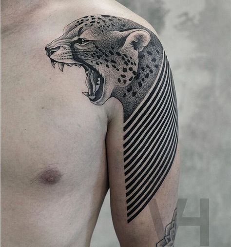 Abstract leopard tattoo on the left shoulder