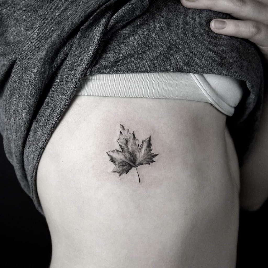 Maple leaf tattoo on the rib