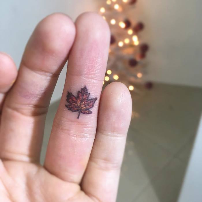 Small brown maple leaf on the ring finger