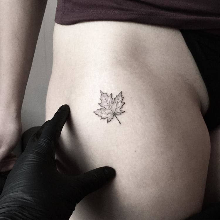 Small maple leaf tattoo on the hip