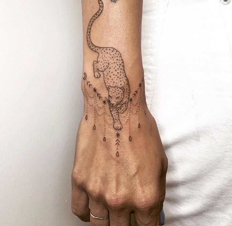 Sneaking leopard tattoo on the hand