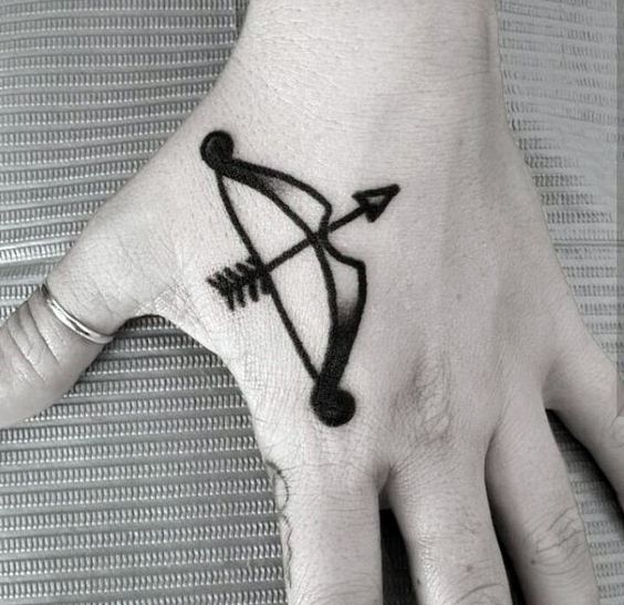 Beautiful blackwork style bow tattoo on the hand