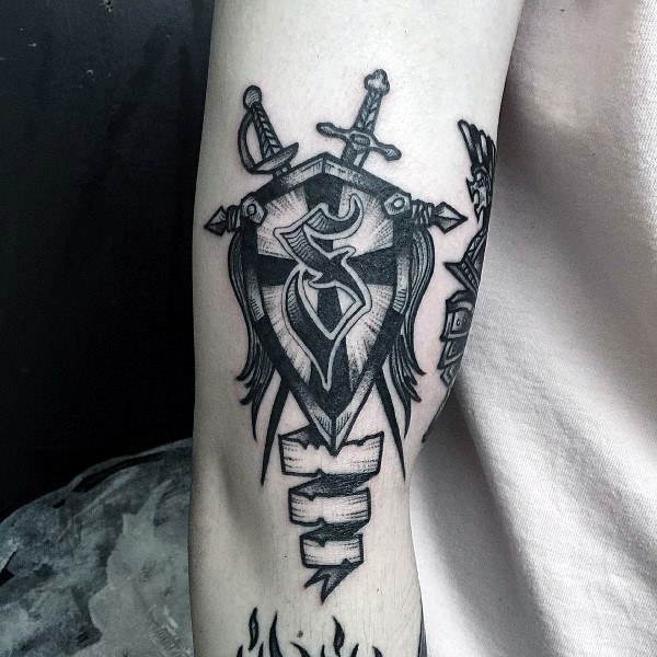 Black shield tattoo with swords