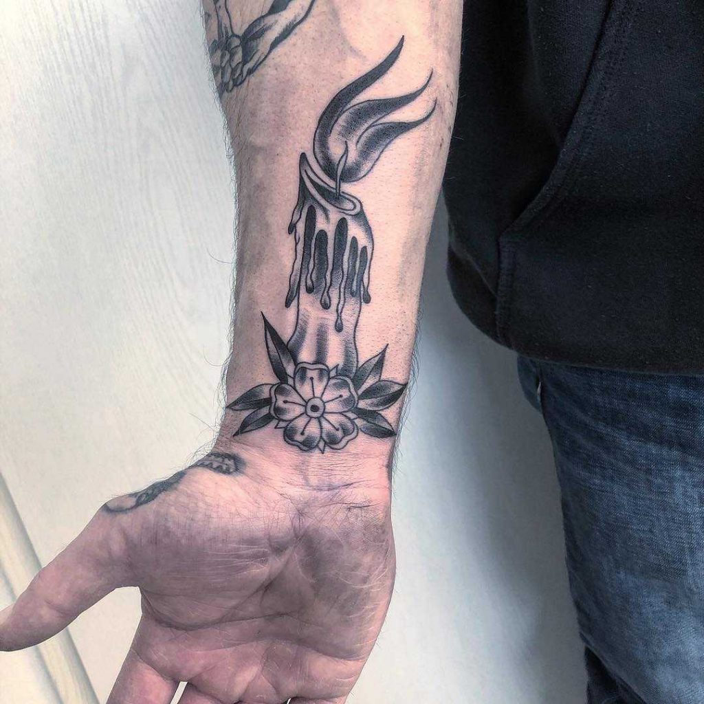 Candle and flower tattoo on the wrist