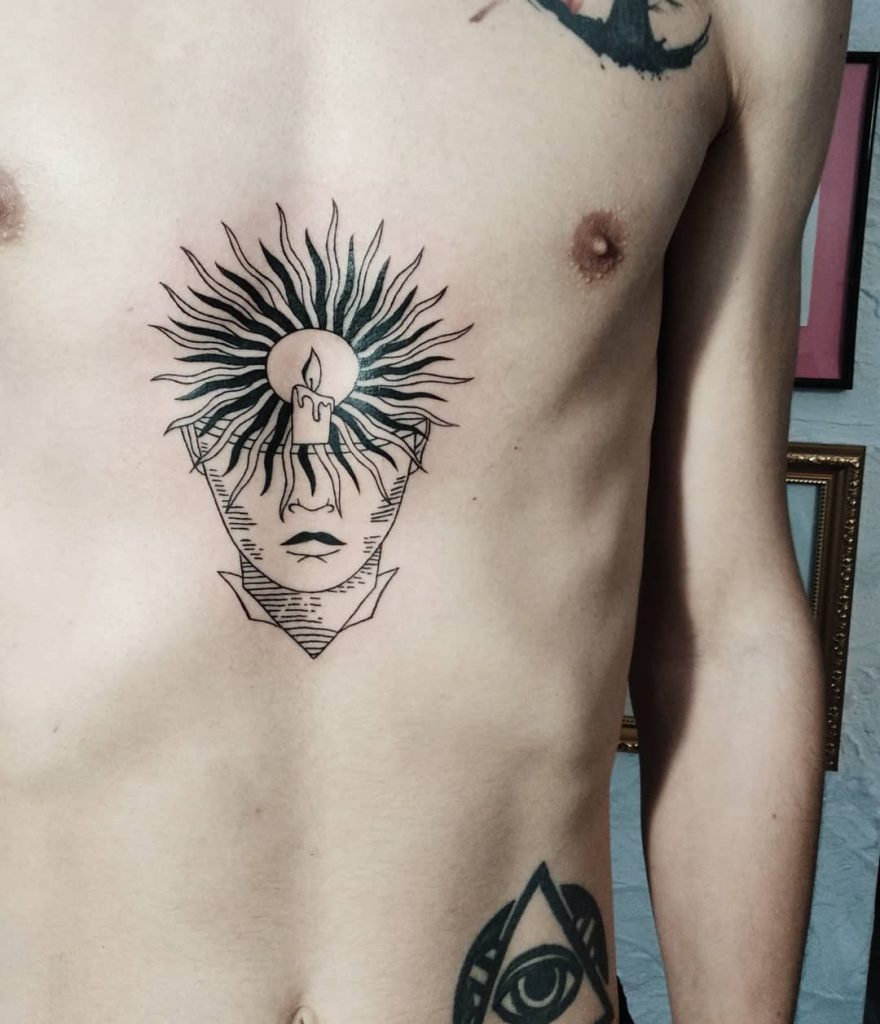 Candle face tattoo on the sternum