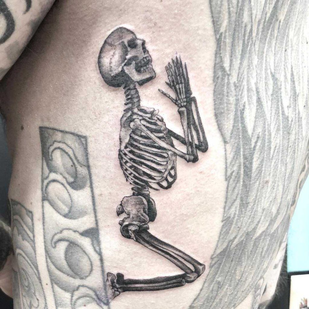 Classic praying skeleton tattoo by Massimo Luciani