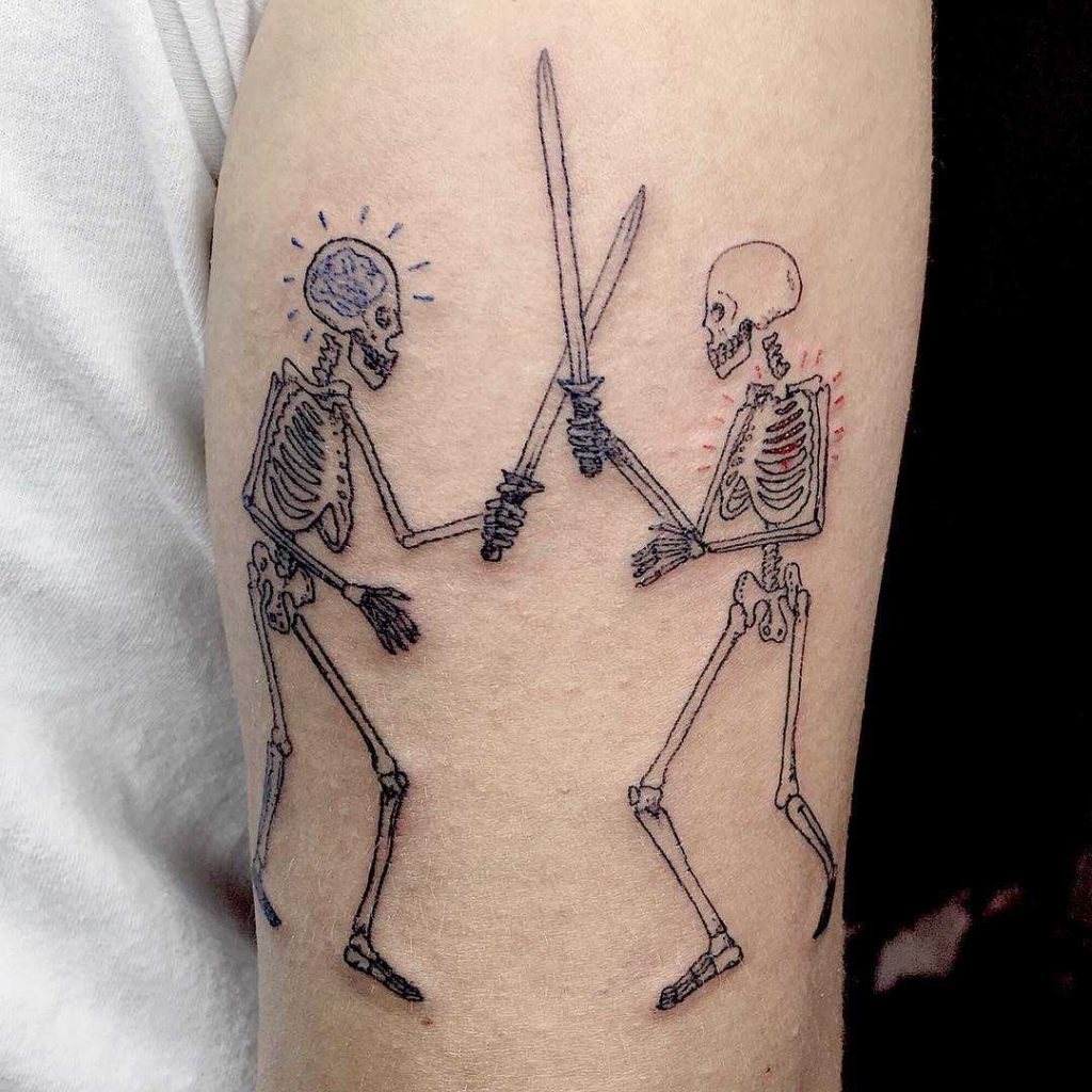 Fighting skeletons tattoo by Melissa Contreras