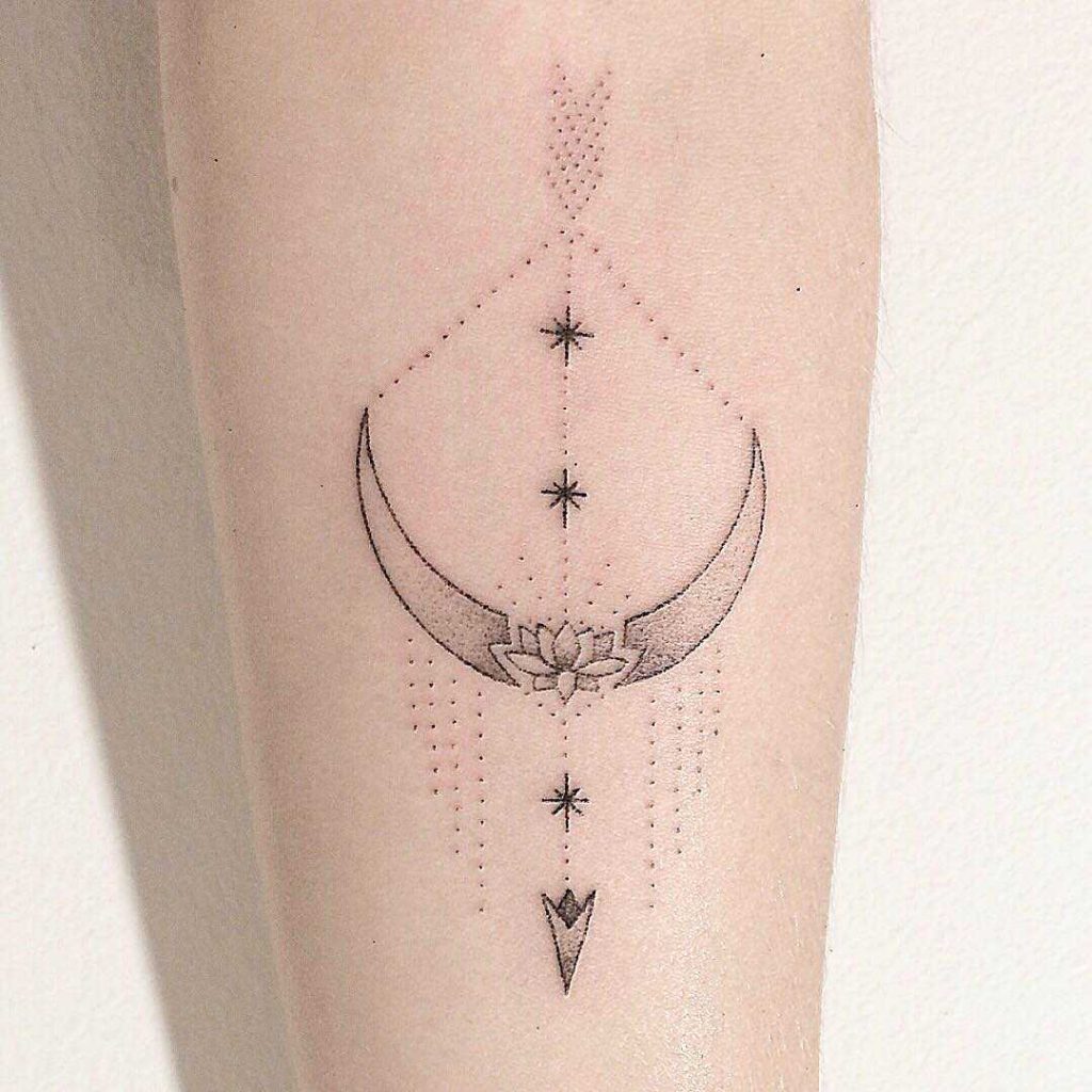Hand-poked crescent moon and arrow tattoo
