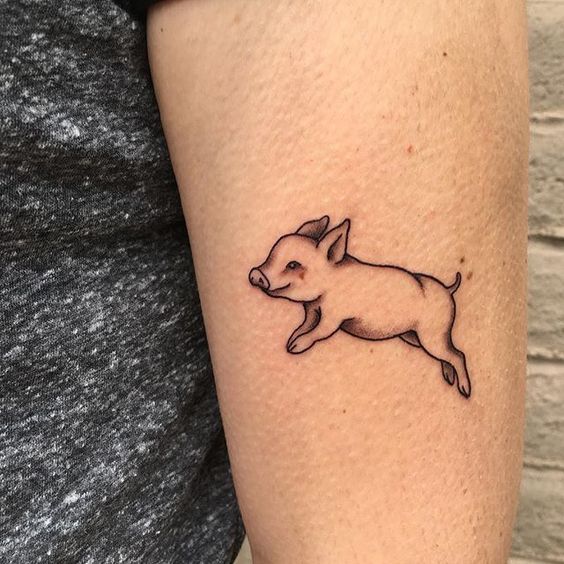 Happy jumping pig tattoo