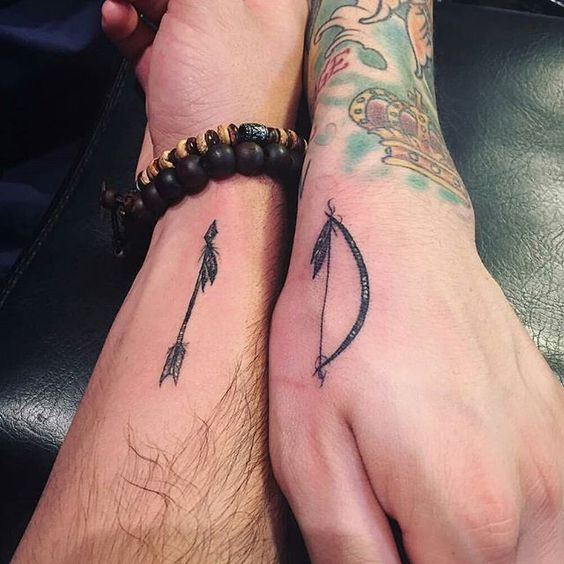 Matching bow and arrow tattoo for a couple