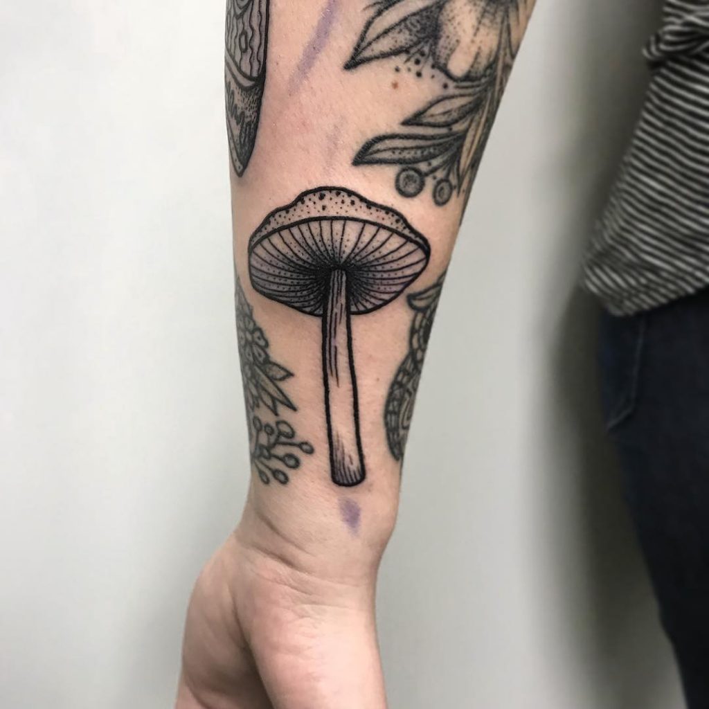 Mushroom tattoo on the wrist by Emma Spyra