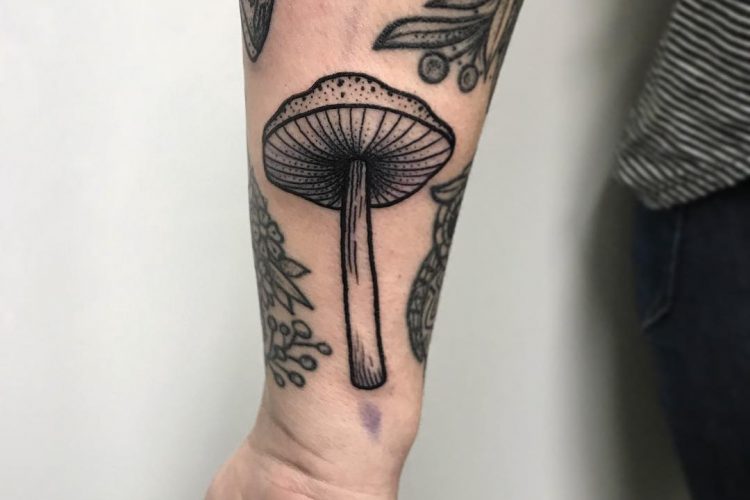 Mushroom tattoo on the wrist by Emma Spyra