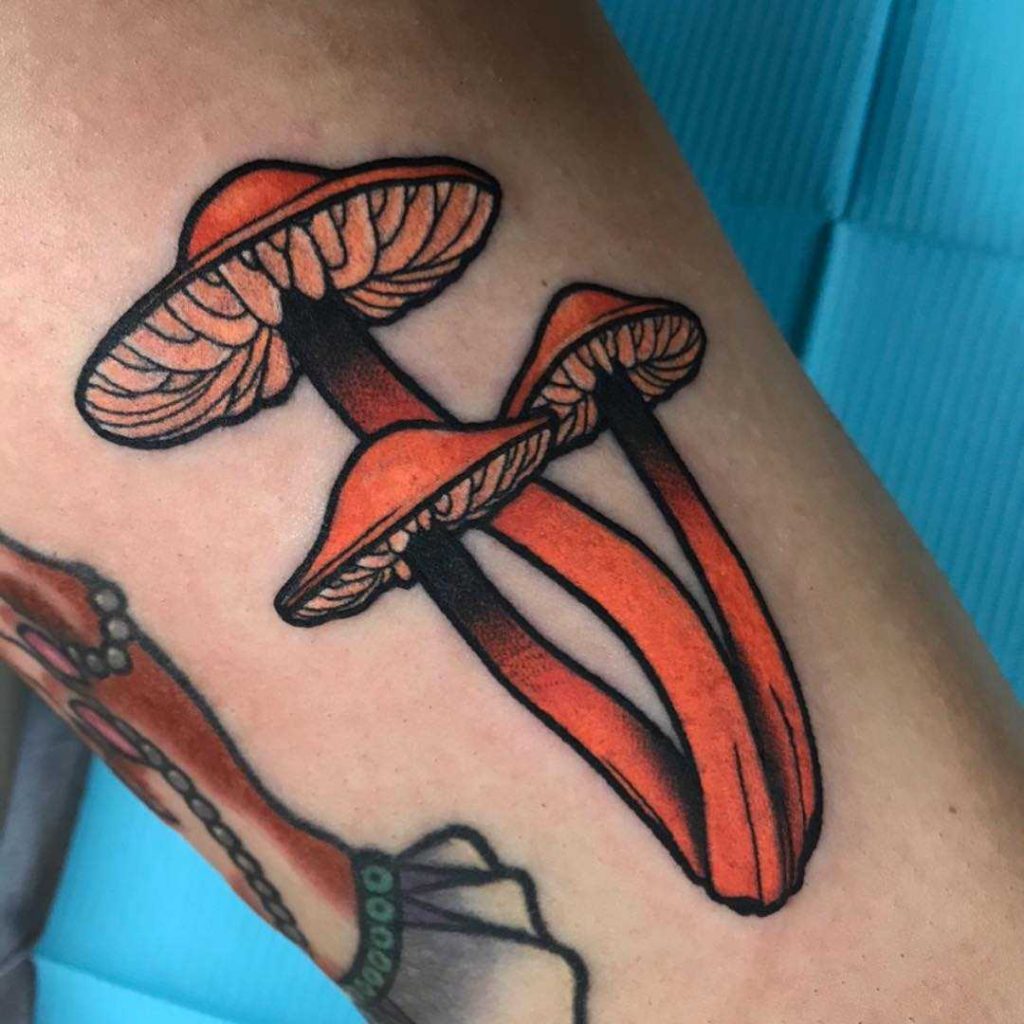Orange mushrooms tattoo by Gaby Uni