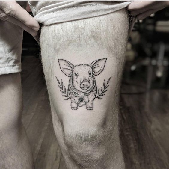 Pig tattoo on the left thigh