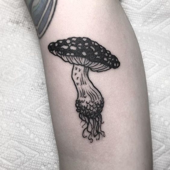 Pretty black mushroom tattoo