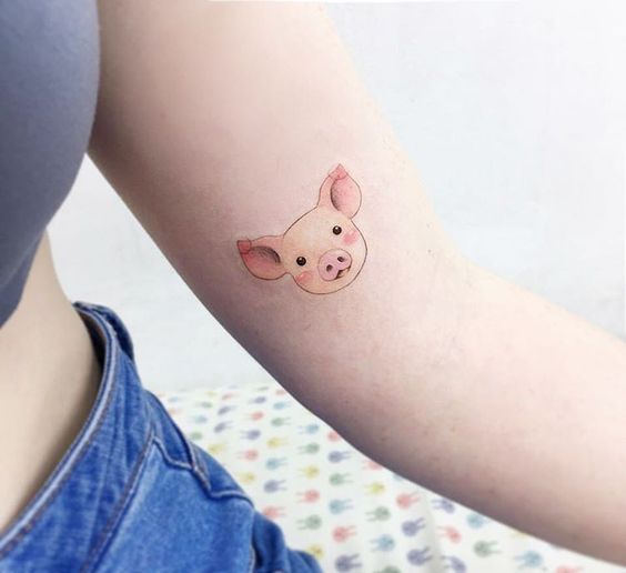 Small pig tattoo on the arm