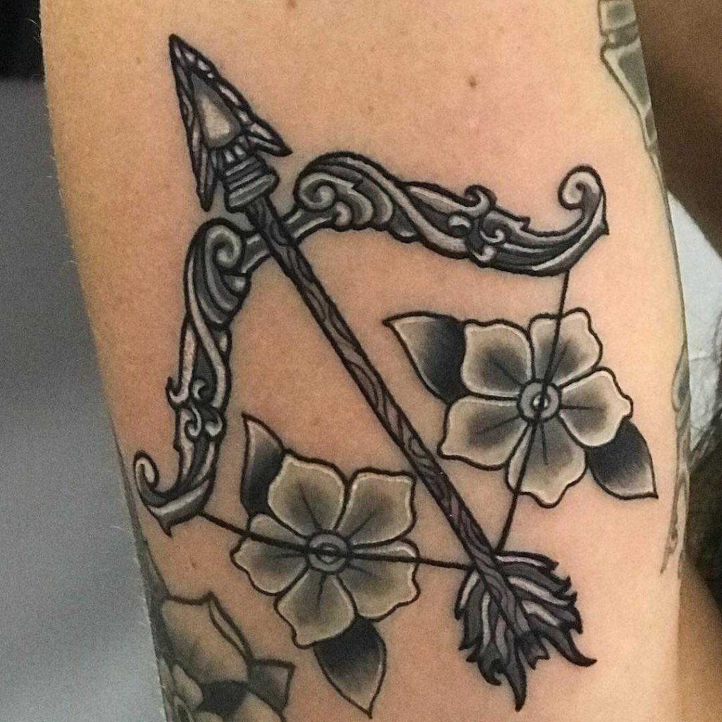 Traditional style bow and arrow with two flowers tattoo by Chad Schloss