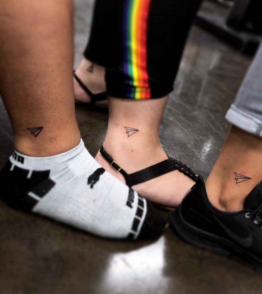 Matching three best friends paper plane tattoos on ankles by tony.inkaholik