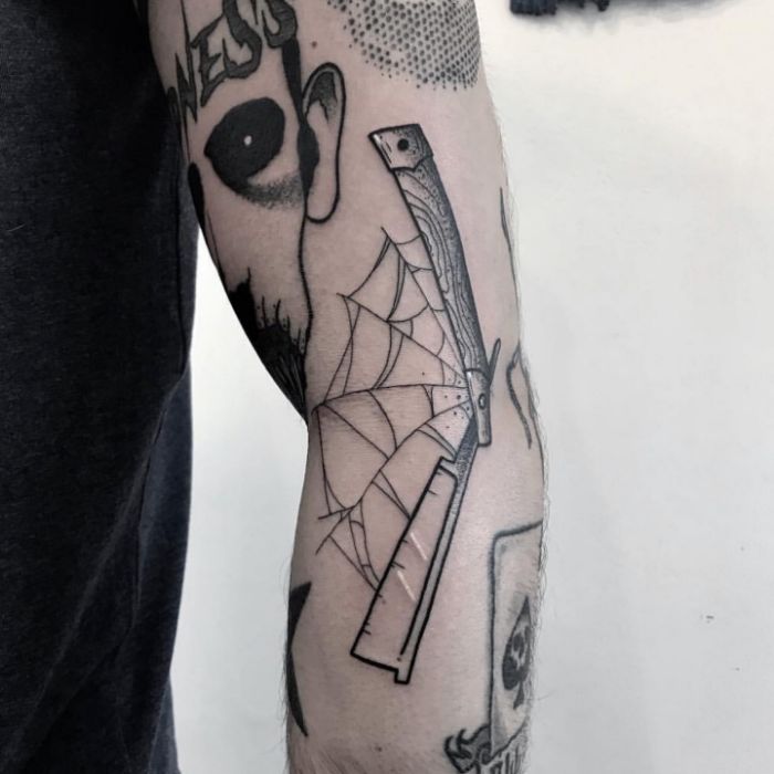 Razor with a spider web inked by @pinkmachinetattoo