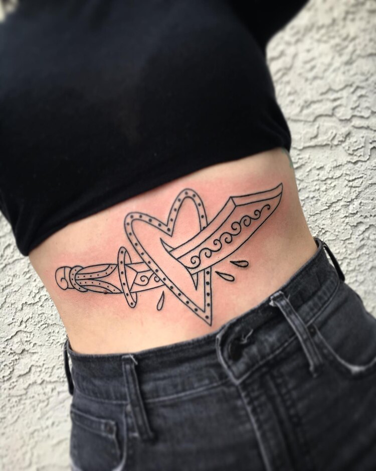 Hipsterish Heart And Dagger Tattoo on a Belly by @jay derita tattoos